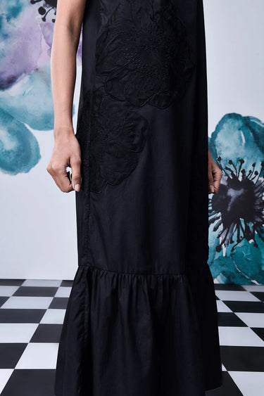 Black midi dress with thin straps styled for evening wear