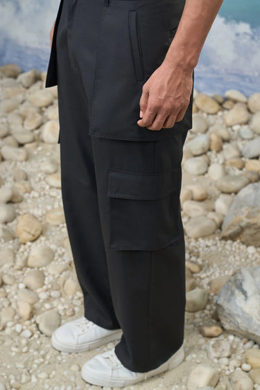 Black poly wool cargo pants for men showing structured breathable fabric texture