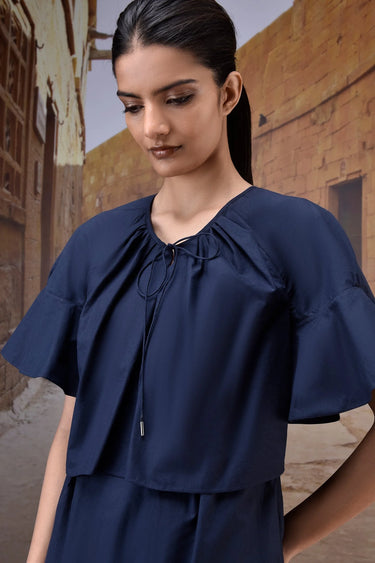 Navy cotton dress with flared flounce sleeves and relaxed silhouette