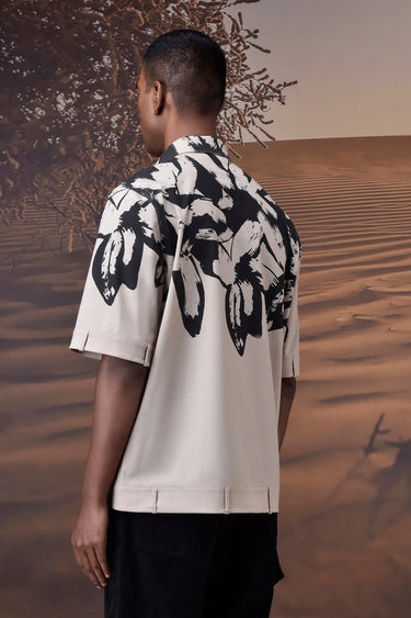Beige abstract print shirt for men styled for travel and warm weather wear