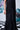 Black midi dress with thin straps styled for evening wear