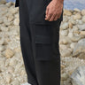 Black poly wool cargo pants for men showing structured breathable fabric texture