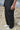 Black poly wool cargo pants for men showing structured breathable fabric texture