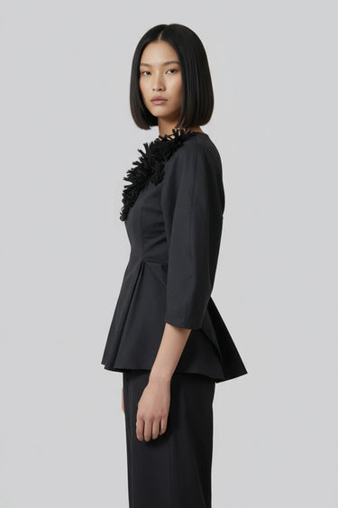 Black peplum top women India with floral embellishment detailing