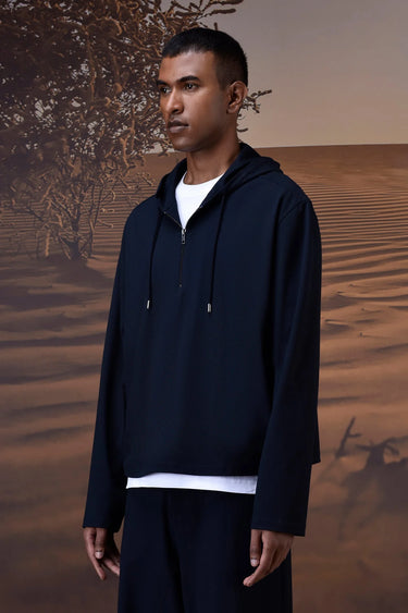 Premium navy hoodie with half-zip closure and adjustable hood in stretch fabric