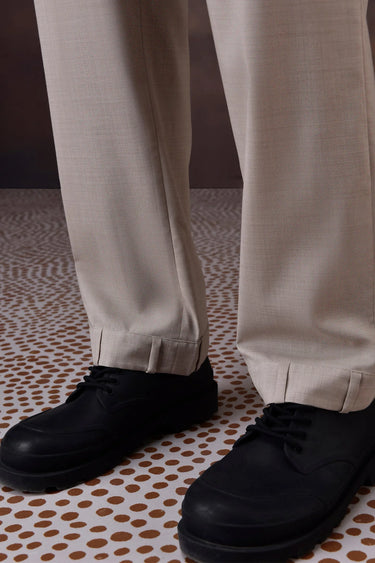 Beige tailored trousers styled for office and smart casual wear