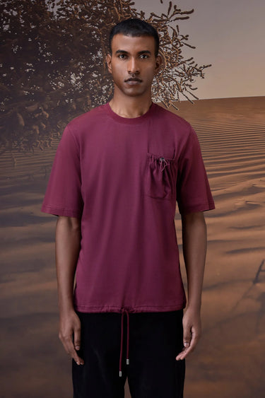 Red textured T-shirt with chest pocket detail and soft cotton fabric