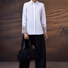 White precision shirt with geometric cutwork sleeves for women by Genes Lecoanet Hemant India